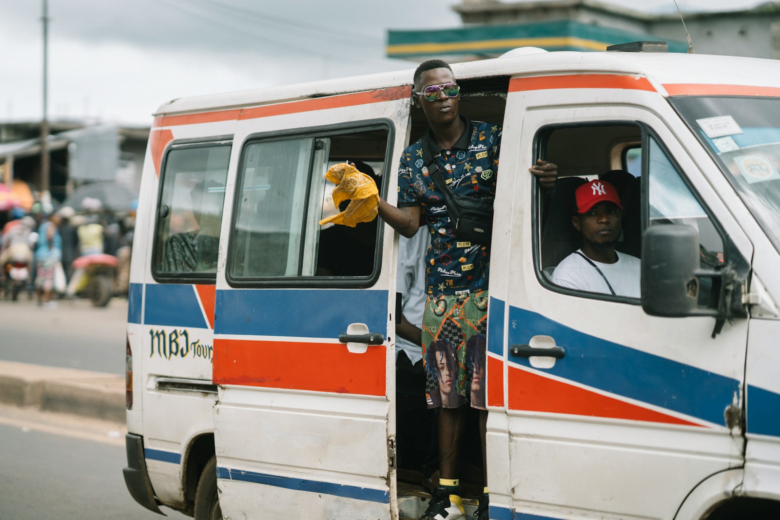 2 women standing beside white and red van