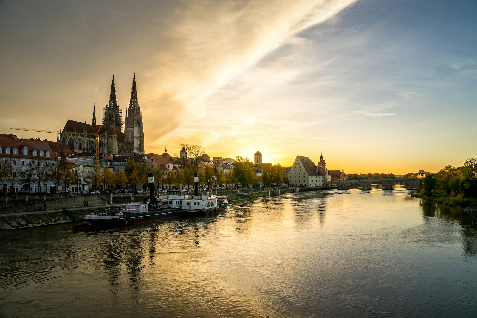 a river with boats on it and buildings on the side