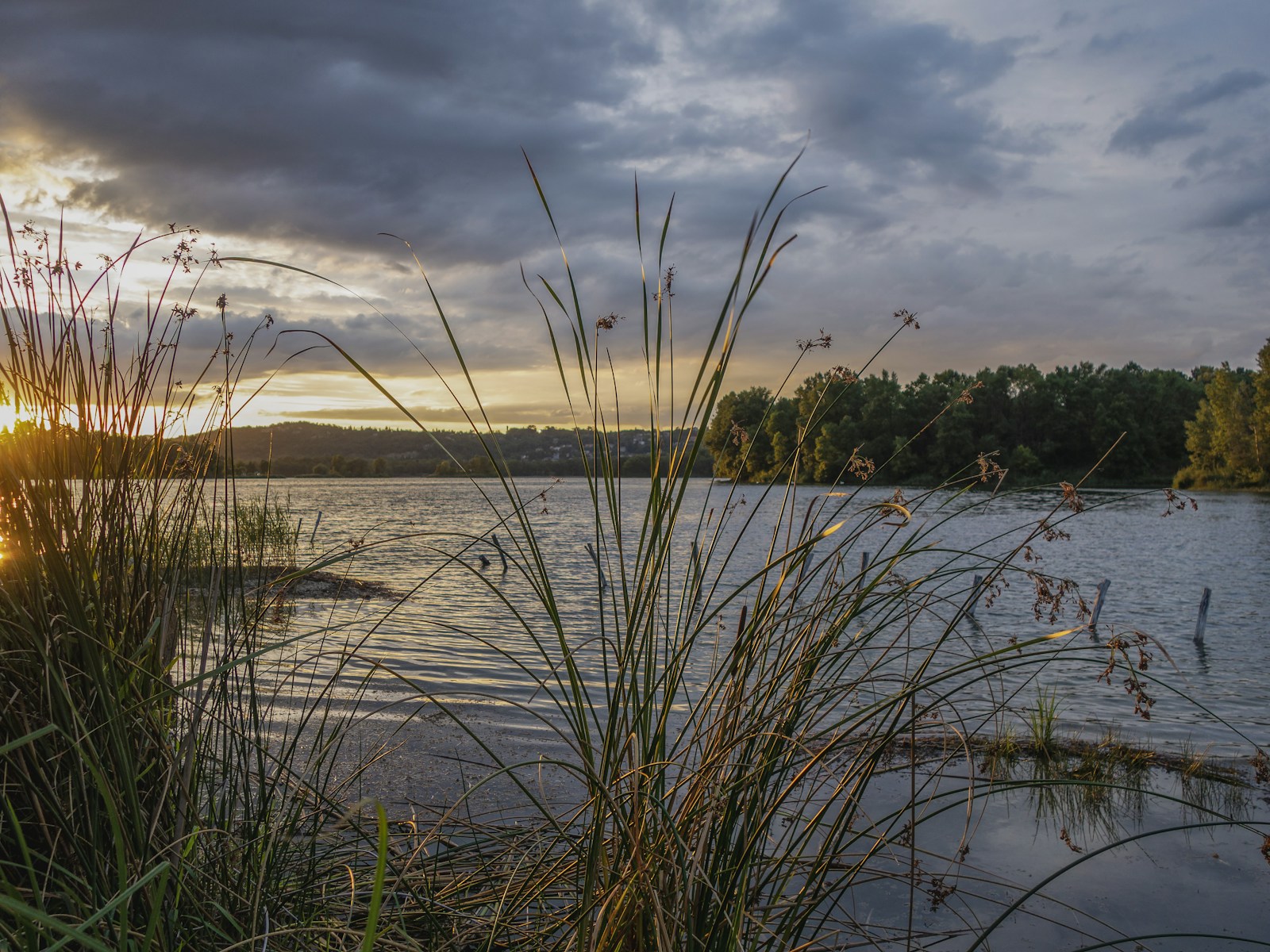 the sun is setting over a body of water