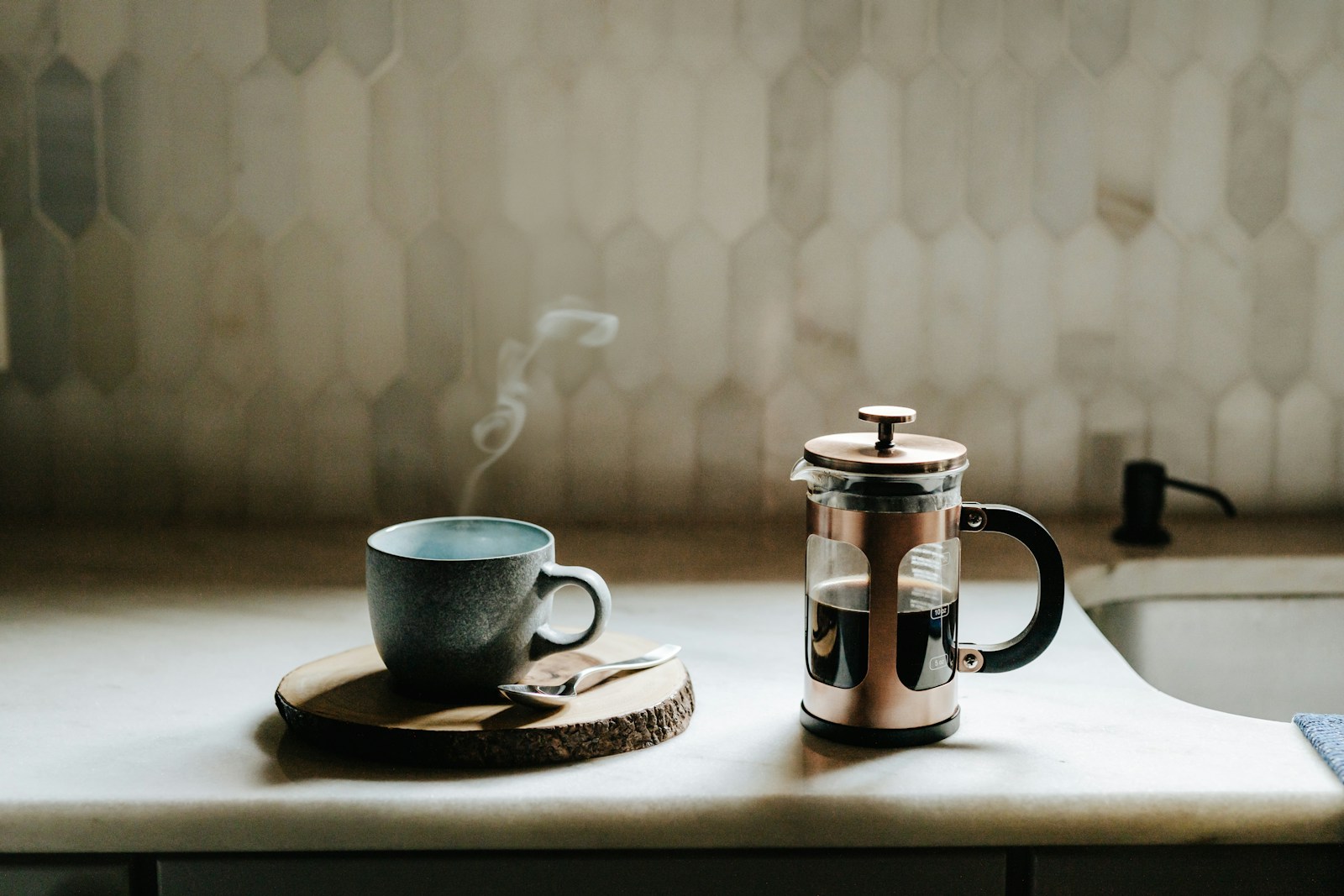 A cup of coffee sitting on top of a kitchen counter