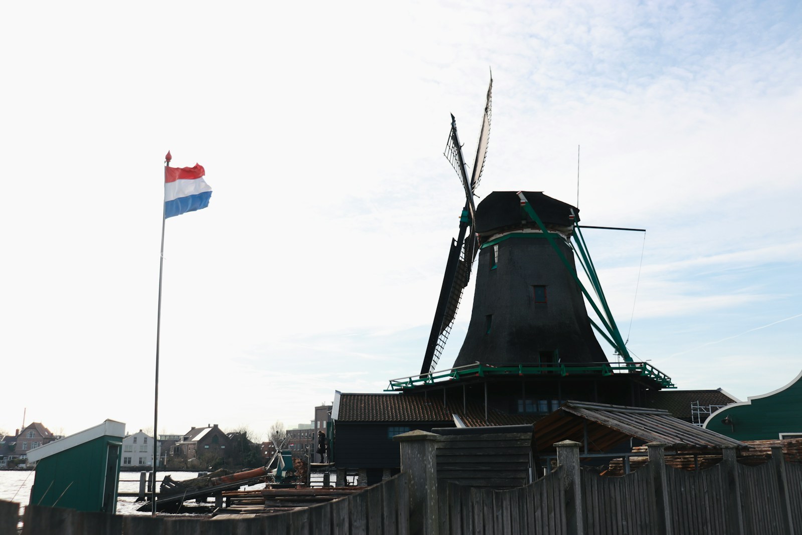 a flag on a pole next to a building