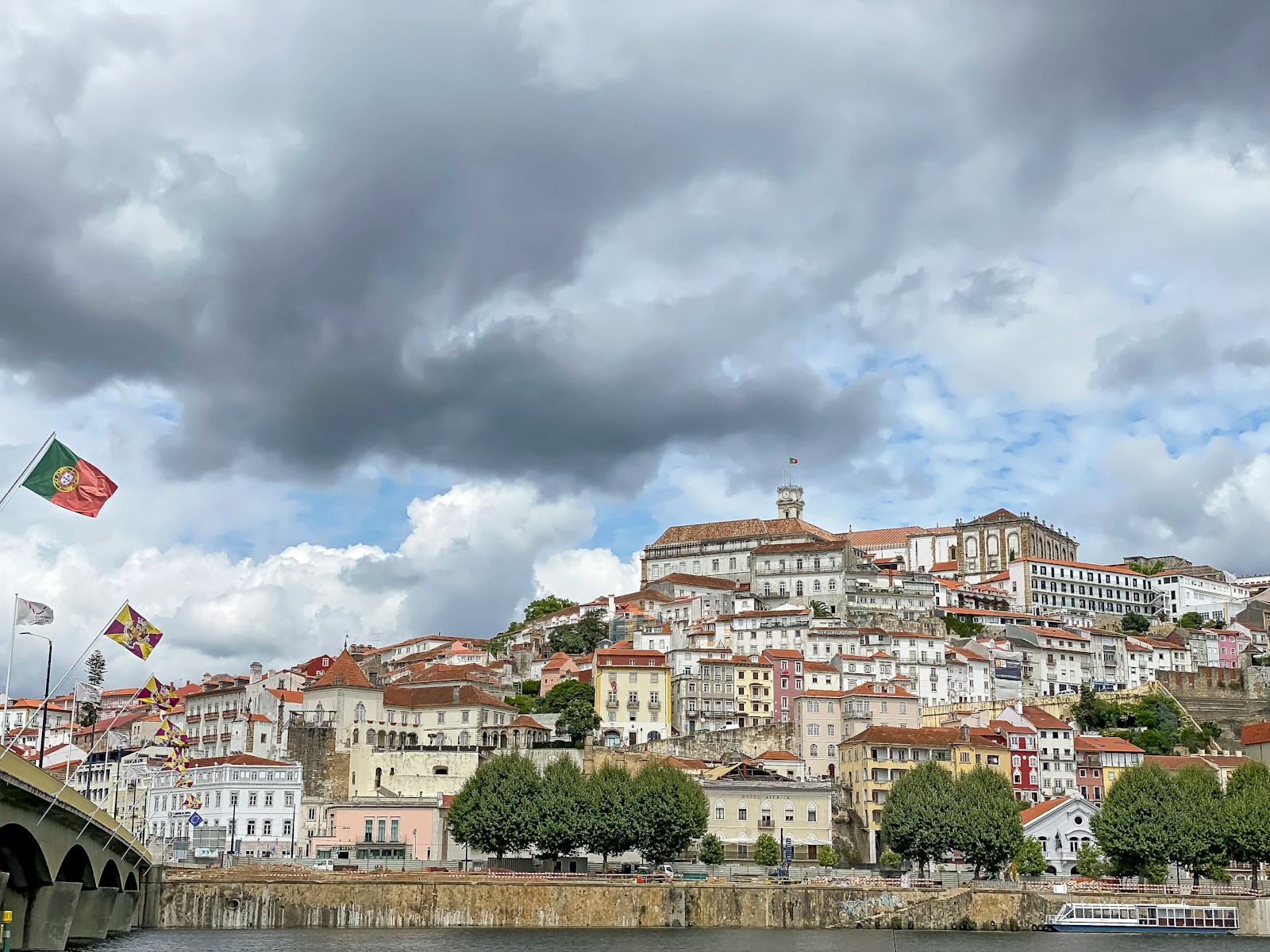 brown and white concrete buildings under white clouds during daytime