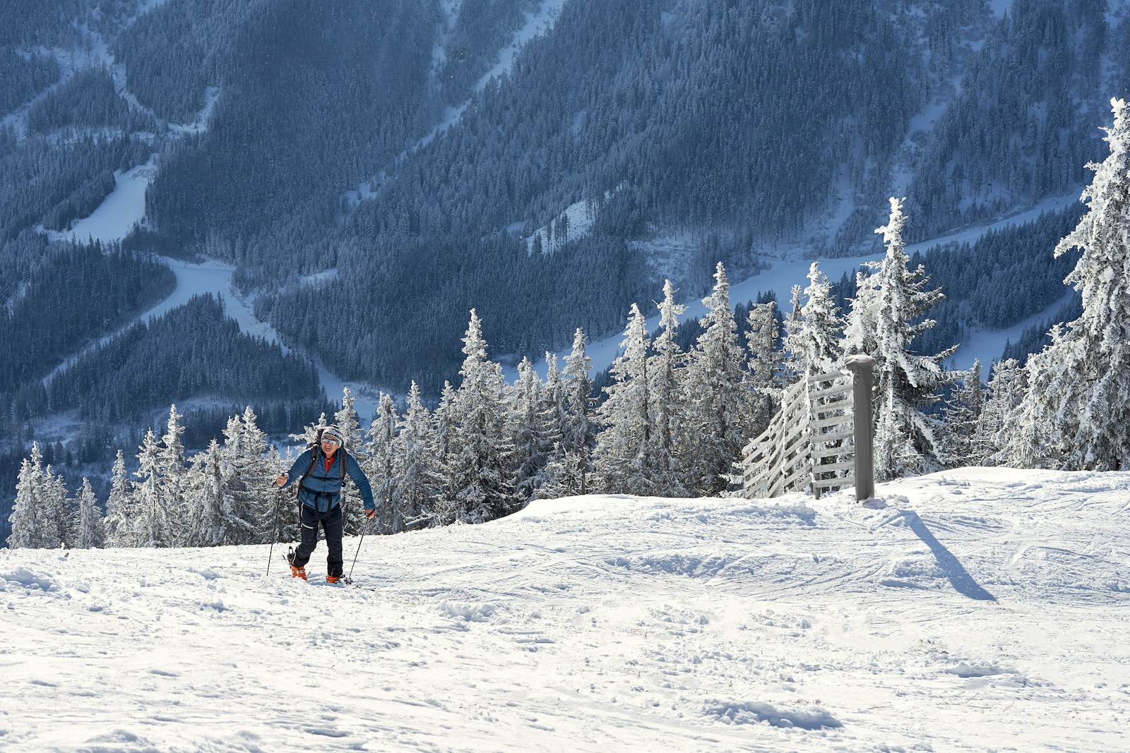 A man riding a snowboard down a snow covered slope